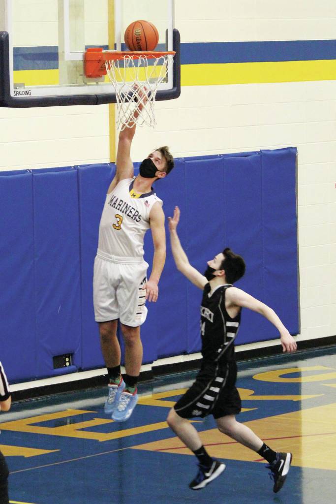 Homers Clayton Beachy sinks a basket in a Tuesday, Feb. 2, 2021 basketball game against Nikiski in the Alice Witte Gymnasium in Homer, Alaska. (Photo by Megan Pacer/Homer News)