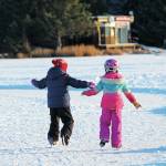 Two children skate around an ice ribbon on Beluga Lake during the Skate the Lake event Saturday, Feb. 6, 2021 in Homer, Alaska. The Homer Hockey Association, which hosted the event, plowed a large skating area as well as several skating ribbons and paths along the lake. (Photo by Megan Pacer/Homer News)