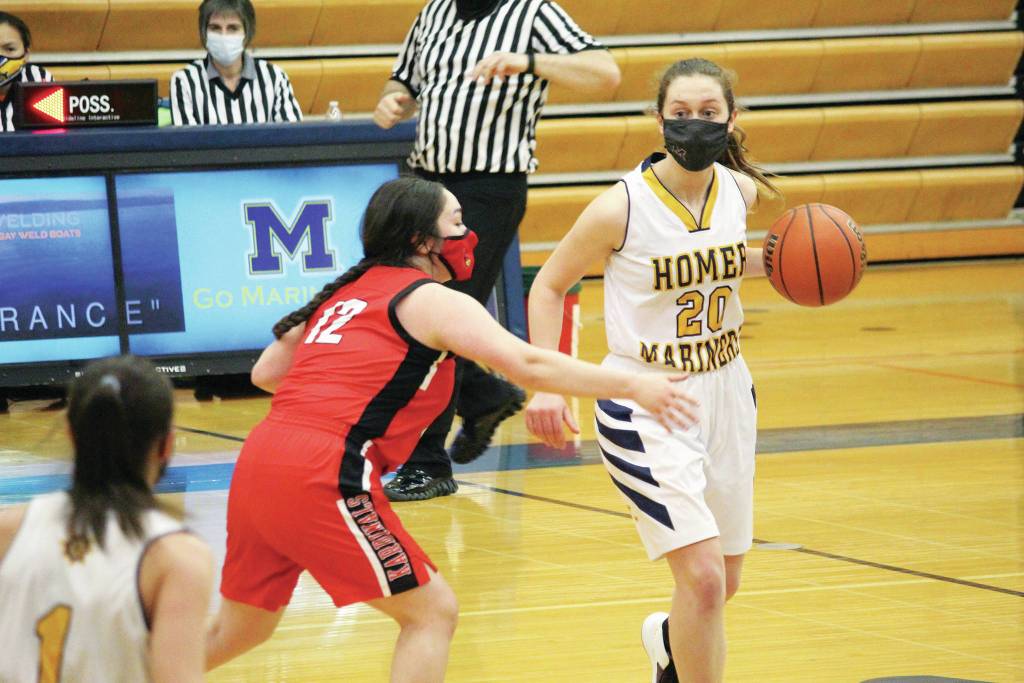 Kenais Michael Keyes guards Homers Mel Morris during a Tuesday, Feb. 9, 2021 basketball game in the Alice Witte Gymnasium in Homer, Alaska. (Photo by Megan Pacer/Homer News)