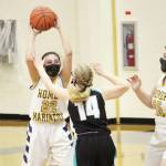 Homer's Hannah Hatfield looks for a teammate to pass to under pressure from Nikiski's Avery White during a Thursday, Feb. 11, 2021 basketball game at the Alice Witte Gymnasium in Homer, Alaska. (Photo by Megan Pacer/Homer News)