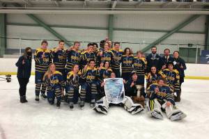 The Homer Mariner hockey team celebrates back to back Division II state hockey championship wins, after defeating the Palmer Moose 3-2 in overtime Saturday, Feb. 20, 2021 at the Curtis D. Menard Memorial Sports Center in Wasilla, Alaska. (Photo by Tim Rockey/Mat-Su Valley Frontiersman)