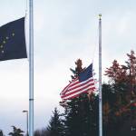 The Alaska and U.S. flags fly at half staff on Monday, Feb. 22, 2021, at the Alaska Islands and Ocean Vistor Center. President Joe Biden on Monday ordered flags to be flown at half staff at federal facilities for five days to honor the 500,000 Americans who have died of COVID-19. (Photo by Michael Armstrong/Homer News)