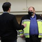 Justin Ruffridge (left) speaks to Dan Nelson (right) at a COVID-19 vaccine clinic on Friday, Feb. 26, 2021 in Soldotna, Alaska. (Photo by Ashlyn OHara/Peninsula Clarion)