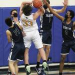 Soldotnas Nathan Johnson (No. 1) and Maleda Denbrock (No. 2) block a basket by Homers Carter Tennison during a Tuesday, March 2, 2021 basketball game in the Alice Witte Gymnasium in Homer, Alaska. (Photo by Megan Pacer/Homer News)