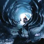 A guide waits for the author to climb through an ice tunnel at the Matanuska Glacier on Jan. 17, 2021 in the Matanuska-Susitna Borough, Alaska. (Photo by Megan Pacer/Homer News)