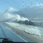 Waves during an extreme high tide and big seas pound the Homer Spit on Sunday afternoon, Feb. 28, 2021, on the Homer Spit, as seen through photographer Malia Anderson's windshield. (Photo by Malia Anderson / Homer News)