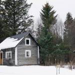 Snow covers the historic Harrington cabin and outhouse on Tuesday, March 9, 2021, at the Pratt Museum in Homer, Alaska. (Photo by Michael Armstrong/Homer News)
