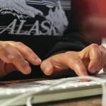 The author works at her former desk at the Peninsula Clarion in 2017 in Kenai, Alaska. (Photo by Ben Boettger)