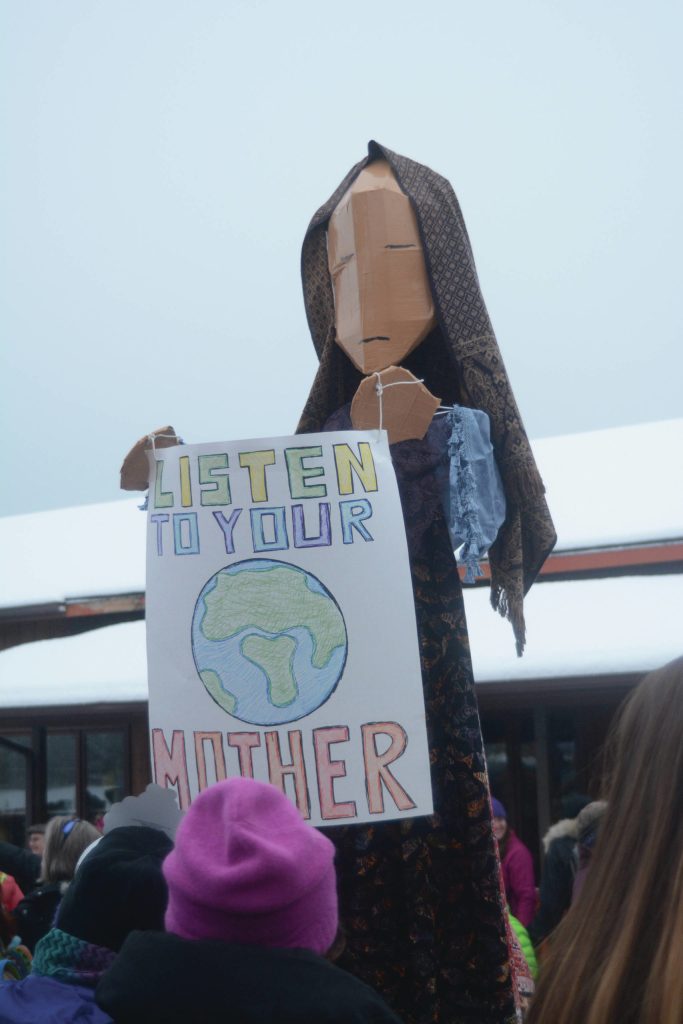 Charles Aguilar operates his puppet of Mother Earth at the start of the Womens March on Saturday, Jan. 21, 2017, in Homer, Alaska. (Photo by Michael Armstrong/Homer News)