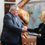 Borough Mayor Charlie Pierce presents local advocate Nona Safra with an exemplary service award Wednesday, March 10, 2021 at the Homer Chamber of Commerce & Visitor Center in Homer, Alaska. (Photo by Megan Pacer/Homer News)