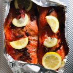 Victoria Petersen/Peninsula Clarion
Salmon dressed up with sun-dried tomatoes and lemons is ready to go in the oven.