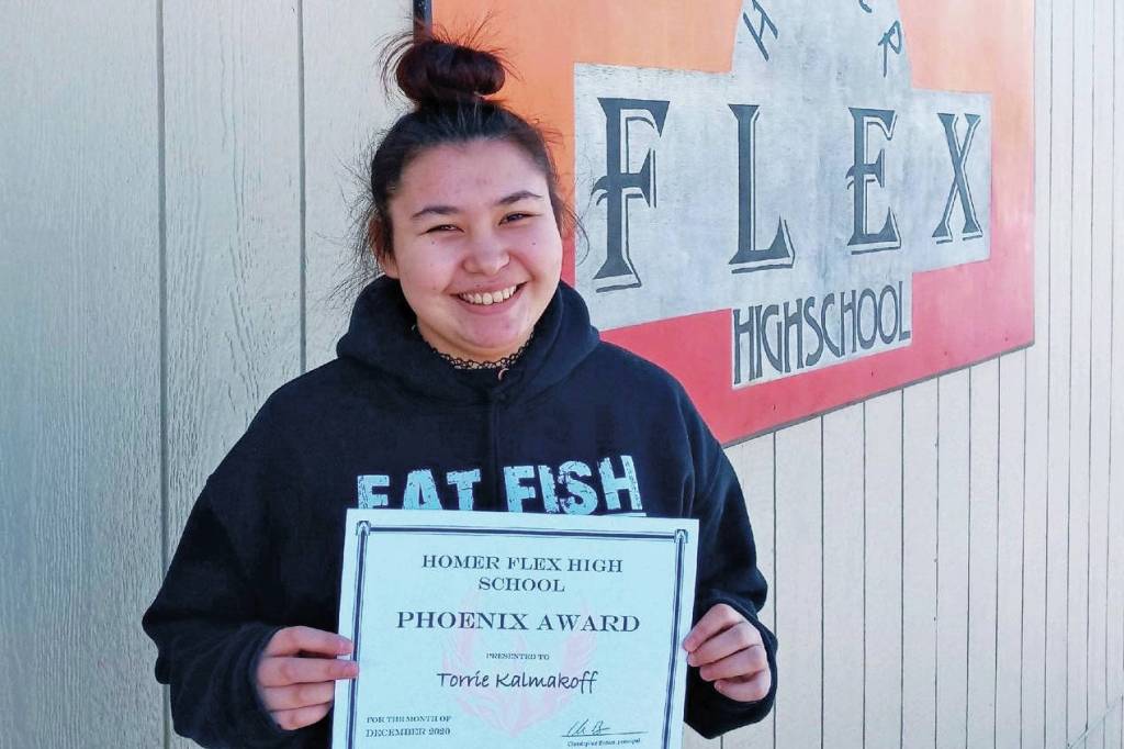 Homer Flex School junior Torrie Kalmakoff stands with her Phoenix Award in this undated photo in front of the school in Homer, Alaska. (Photo courtesy Beth Schneider/Homer Flex School)
