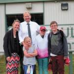 Eric Pederson, principal of Paul Banks Elementary School, stands with his family outside the school in this undated photo in Homer, Alaska. (Photo courtesy Eric Pederson)