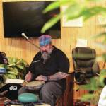 Darren Williams, owner of the Plant Man, plays a drum in his newly expanded space in the Wildberry Building on Pioneer Avenue on Feb. 19, 2021 in Homer, Alaska. (Photo by Megan Pacer/Homer News)