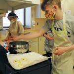 Zoe Adkins (left) and Emmet Wilkinson (right) prepare pretzels in a high school food and nutrition class at Homer High School in Homer, Alaska. (Photo by Katelyn Engebretsen/Homer High Yearbook)