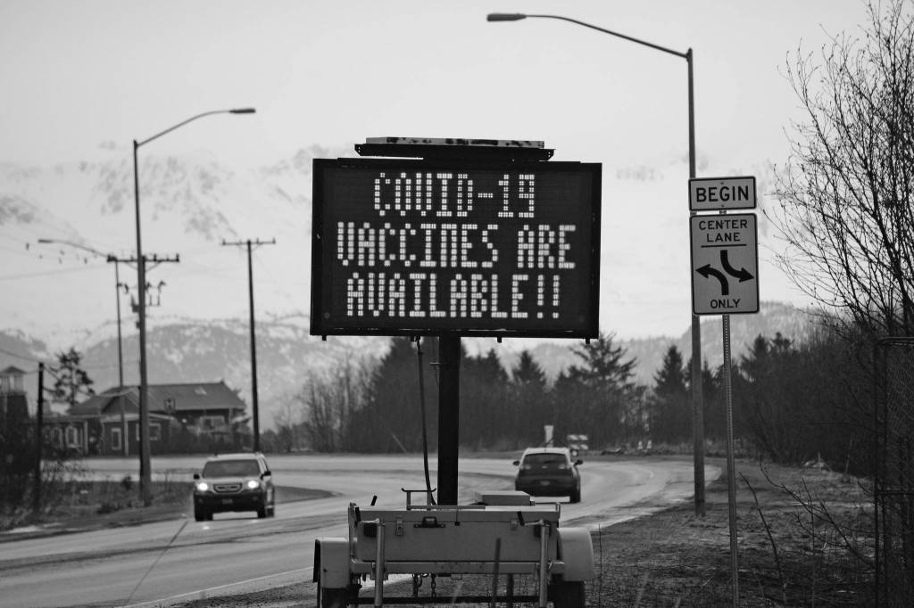 A sign on Tuesday, March 30, 2021, on the Sterling Highway near Soundview Avenue announces the availability of COVID-19 vaccines in Homer, Alaska, . (Photo by Michael Armstrong/Homer News)