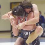 Photo by Jeff Helminiak/Peninsula Clarion 
Homers Nestor Kalugin tries to control Nikiskis Simon Grenier at 171 pounds Tuesday, March 30, 2021, at Nikiski High School in Nikiski, Alaska. Grenier won by 10-4 decision.
