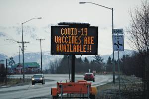 A sign on Tuesday, March 30, 2021, on the Sterling Highway near Soundview Avenue announces the availability of COVID-19 vaccines in Homer, Alaska, . (Photo by Michael Armstrong/Homer News)