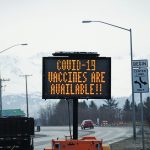 A sign on Tuesday, March 30, 2021, on the Sterling Highway near Soundview Avenue announces the availability of COVID-19 vaccines in Homer, Alaska, . (Photo by Michael Armstrong/Homer News)