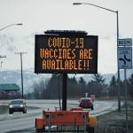 A sign on Tuesday, March 30, 2021, on the Sterling Highway near Soundview Avenue announces the availability of COVID-19 vaccines in Homer, Alaska, . (Photo by Michael Armstrong/Homer News)