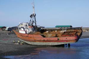 Crews work on a boat on Monday, April 5, 2021, at the large-vessel haul out beach on the Homer Spit near the Pier 1 Theatre in Homer, Alaska. In the off season boats are hauled onshore for repair at the beach near the Nick Dudiak Fishing Lagoon. (Photo by Michael Armstrong/Homer News)