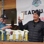 Capt. Jay Marley of the Fly Dough accepts the captains award for the boat that had the first-place fish in the 2021 Homer Winter King Salmon Tournament. Marleys son, Andrew, caught the 25.62-pound winner. Homer Chamber of Commerce and Visitor Center Executive Director Brad Johnson, left, presented the plaque on Saturday, April 17, 2021, on the Homer Spit in Homer, Alaska. (Photo by Michael Armstrong/Homer News)