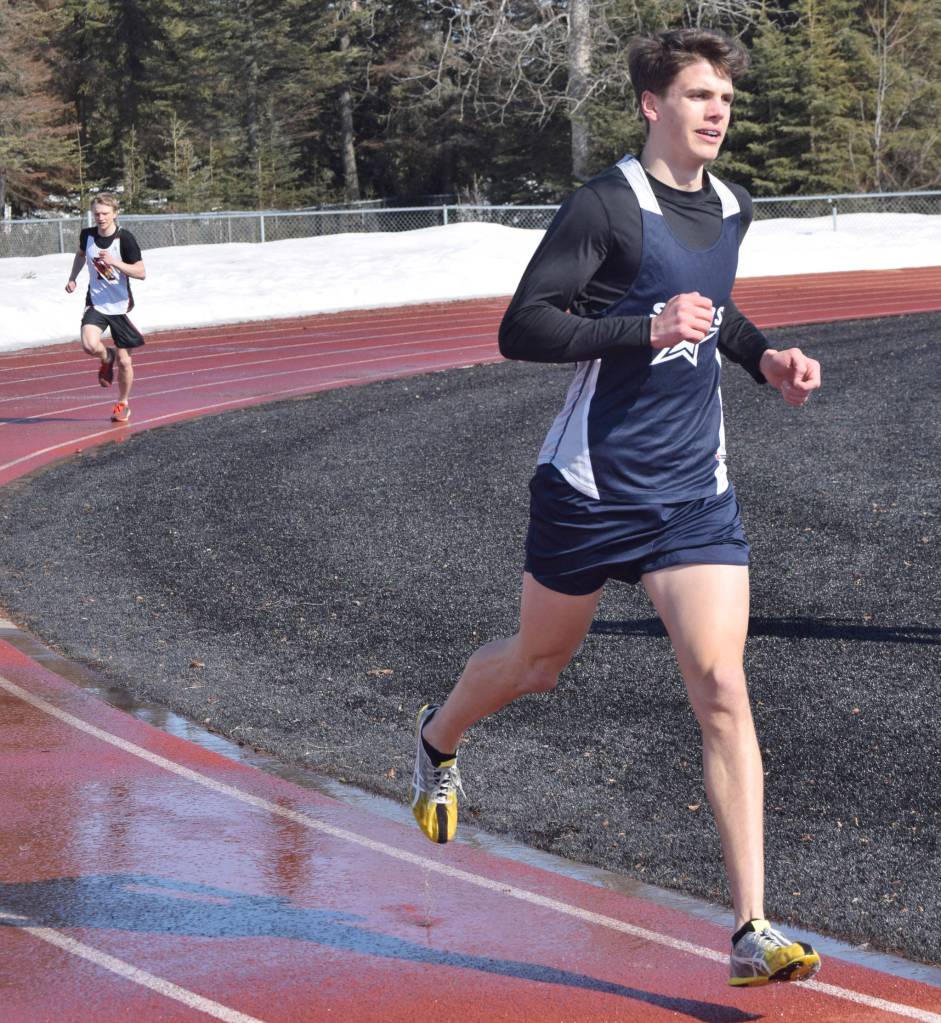 Soldotnas Nathanael Johnson leads Kenai Centrals Jack Laker on the way to victory in the 1,600-meter run in a dual meet Friday, April 16, 2021, at Kenai Central High School in Kenai, Alaska. (Photo by Jeff Helminiak/Peninsula Clarion)