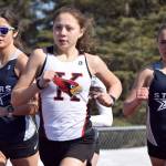 Kenai Central's Emilee Wilson leads Soldotna's Erika Arthur and Jordan Strausbaugh during the 800-meter run during a dual meet Friday, April 16, 2021, at Kenai Central High School in Kenai, Alaska. (Photo by Jeff Helminiak/Peninsula Clarion)