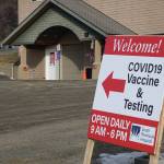 A sign on Friday, April 1, 2021, points the way to COVID-19 vaccines and testing at the South Peninsula Hospital testing and vaccine site on Bartlett Street in Homer, Alaska. (Photo by Michael Armstrong/Homer News)