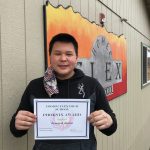 Armond Allain poses on April 23, 2021, with his February Homer Flex School Phoenix Award at Flex School in Homer, Alaska. (Photo by Elizabeth Schneider / Homer Flex School)