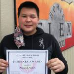 Armond Allain poses on April 23, 2021, with his February Homer Flex School Phoenix Award at Flex School in Homer, Alaska. (Photo by Elizabeth Schneider / Homer Flex School)