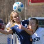 Soldotna's Jolie Widaman and Homer's Kappa Reutov challenge for the ball Saturday, April 24, 2021, at Kenai Central High School in Kenai, Alaska. (Photo by Jeff Helminiak/Peninsula Clarion)