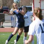 Photo by Jeff Helminiak/Peninsula Clarion 
Soldotnas Jolie Widaman and Homers Kappa Reutov challenge for the ball Saturday, April 24, 2021, at Kenai Central High School in Kenai, Alaska.