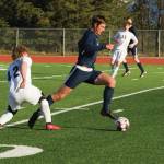 Mariners Clayton Beachy dribbles the ball toward the goal against Grace Christian School April 30, 2021, at the Homer High School soccer field. (Photo by Sarah Knapp/Homer News)
