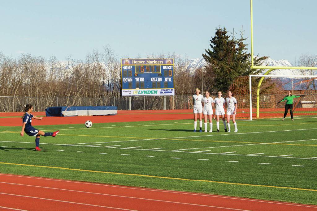 Lady Mariners' Debbie Weisser executes a penalty kick against Grace Christian School during the soccer game April 30; 2021; at the Homer High School soccer field. (Photo by Sarah Knapp/Homer News)