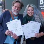 Homer News editor Michael Armstrong, left, and former reporter Megan Pacer, right, hold Alaska Press Club awards the Homer News received at the Alaska Press Club Awards banquet on April 27, 2019, in Anchorage, Alaska. Armstrong and Pacer also won awards for the 2020 contest year. (Photo by Brian Mazurek/Peninsula Clarion)