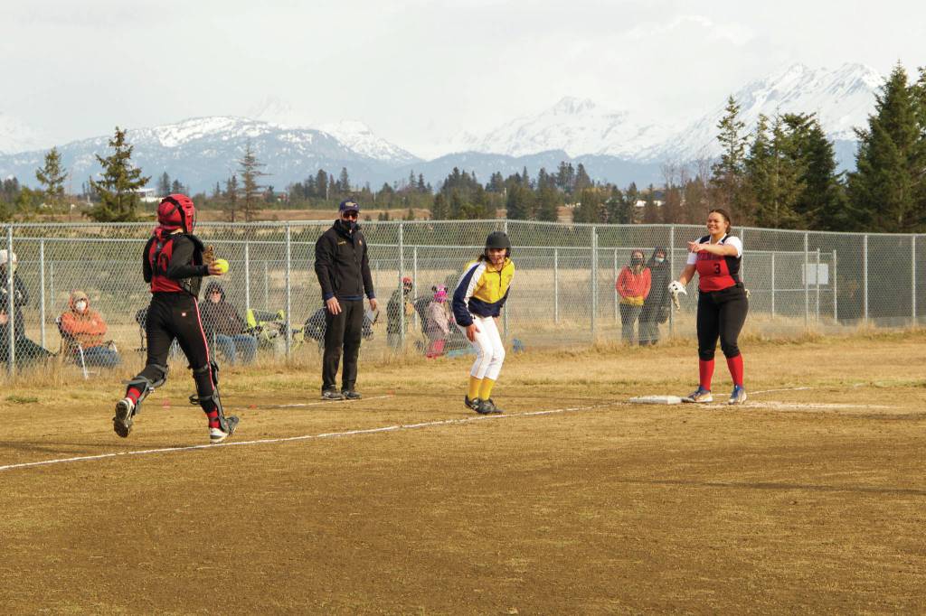 Kenai catcher chases Mariners Haylee Owen back to third base during the home softball game May 4, 2021, at Jack Gist Park. (Photo by Sarah Knapp/Homer News)