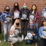 The Homer High School yearbook staff received a Jostens' national award for the 2021 yearbook. The yearbook "Our Story 202One" was credited for its inclusivity and creativity. Pictured is the yearbook staff with the yearbook. Back row left to right: Kamdyn Doughty, Katelyn Engebretsen, Madison Story, Paige Jones, Hannah Hatfield and Tristyn Romeril. Bottom row: Mya Houglum, Suzanne Bishop and Mariah McGuire. Photo submitted by Suzanne Bishop.