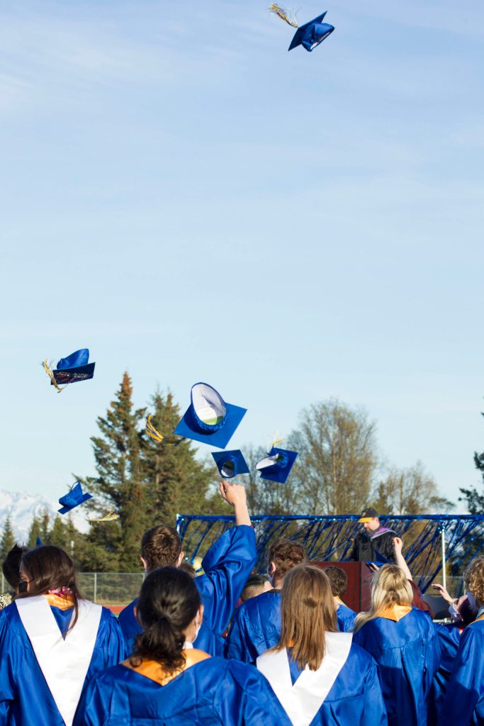 Homer High School graduates through their caps in the air after receiving their diplomas on May 18. (Photo by Sarah Knapp/Homer News)