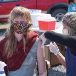 South Peninsula Hospital registered nurse Anne Garay gives Jessica Entsminger her second COVID-19 vaccine on Friday, May 7, 2021, at a pop-up vaccination clinic at the Boathouse Pavillion on the Homer Spit in Homer, Alaska. About 25 people received vaccines in the first 3.5 hours of the 4-hour clinic. (Photo by Michael Armstrong/Homer News)