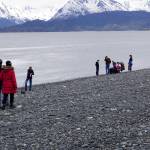 A couple walks along the beach, left, as a family fishes on Friday, May 21, 2021, at the end of the Homer Spit in Homer, Alaska. (Photo by Michael Armstrong/Homer News)