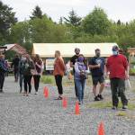 People walk through a pared down version of the Homer Farmers Market on Saturday, May 30, 2020 in Homer, Alaska. (Photo by Megan Pacer/Homer News)