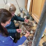 Tour guests at Jars of Clay admire a collection of small bear sculptures by Ash Merkel on Saturday, May 15, 2021, in Homer, Alaska. (Photo by Tara Schmidt)