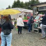 Homer community members stand in line at the farmers market to purchase coffee. The Farmers Market returned Saturday, May 29.