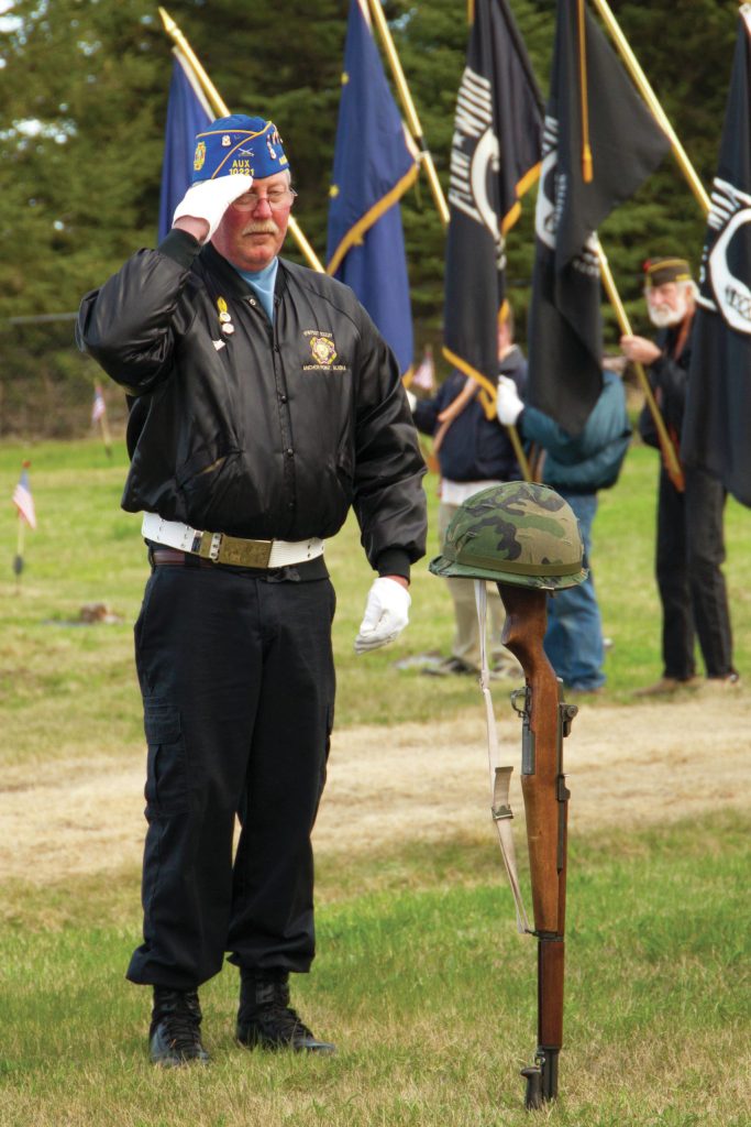 A veteran salutes the fallen soldier memorial during the 2021 Memorial Day service held at Hickerson Memorial Cemetery on May 31. (Photo by Sarah Knapp/Homer News)