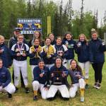 The Homer Mariner softball team celebrates after winning the Northern Lights Conference in an 18-17 win over Kodiak. At far left, back, is Coach Bill Bell, and at far right is Assistant coach Mary Hana Bowe. (Photo courtesy Homer Mariner Softball team)