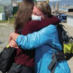 Alaska Chief Medical Officer Anne Zink, M.D., left, hugs Amy Russell, right, on Thursday, May 27, 2021, at a pop-up vaccination clinic on the Homer Spit in Homer, Alaska. (Photo by Sarah Knapp/Homer News)