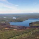 This photo taken at 11:30 a.m. today, Monday, June 14, reveals little smoke rising from the Loon Lake Fire following Sundays aerial attack by water and retardant bombing aircraft. The fire denoted by the burned area at the edge of the lake. (Jason Jordet/Division of Forestry Air Attack)