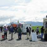 People line up at food trucks and trailers on Saturday, June 19, 2021, at the Kevin Bell Ice Arena parking lot on the Homer Spit in Homer, Alaska. Part of the Homer Chamber of Commerce and Visitor Center's Food Fest last week, the two-day food truck event drew a steady crowd. (Photo by Michael Armstrong/Homer News)