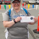 Jess Riley, who walked in the untimed 10K on June 26, was randomly selected to win a Homer Flightseeing trip from Kachemak Air Service. (Photo by Sarah Knapp/Homer News)